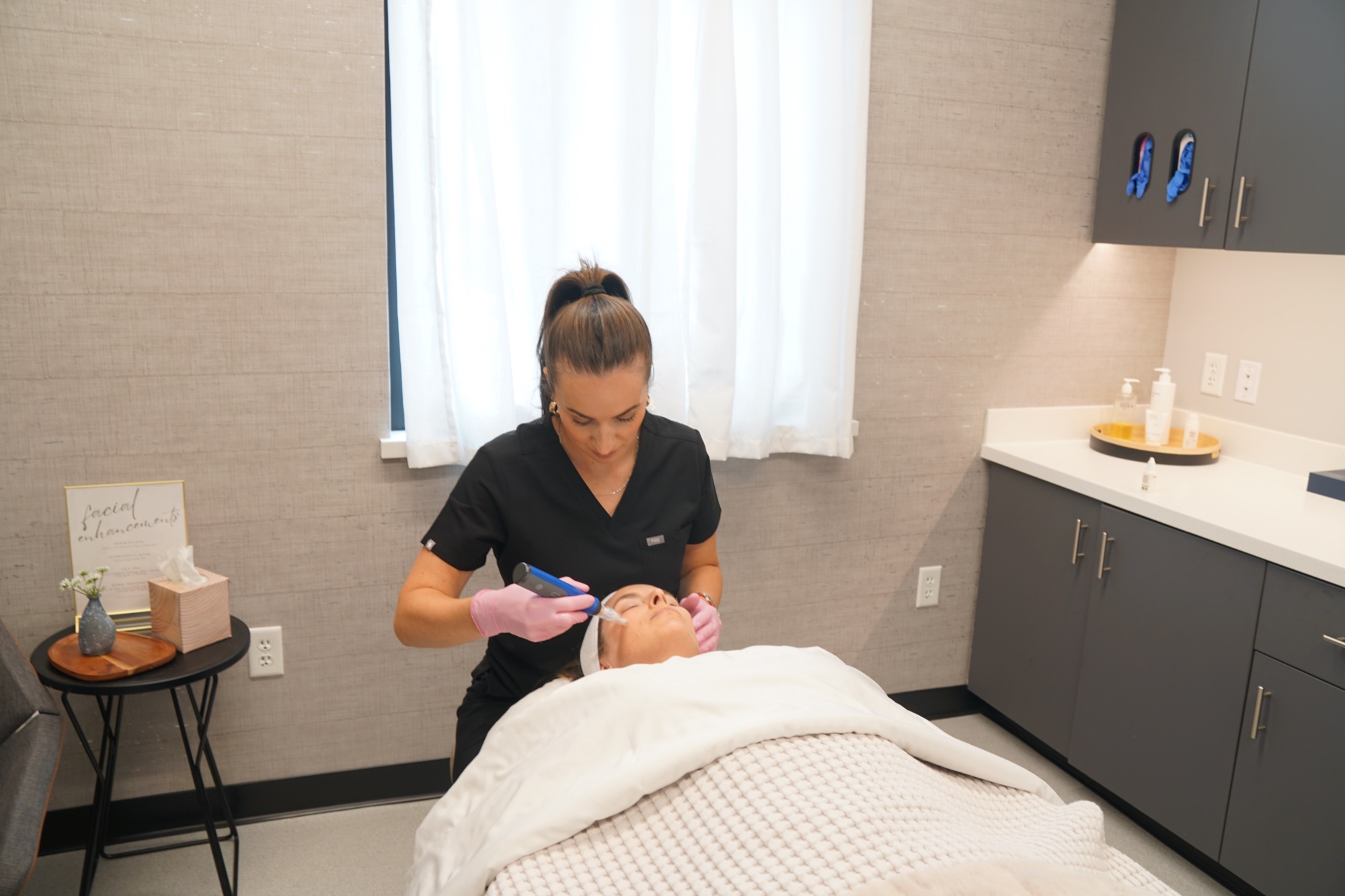Alena, Licensed Master Esthetician at Sand Plastic Surgery, performing a facial treatment